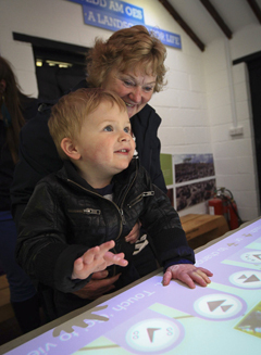 Family using the Audio Visual exhibition